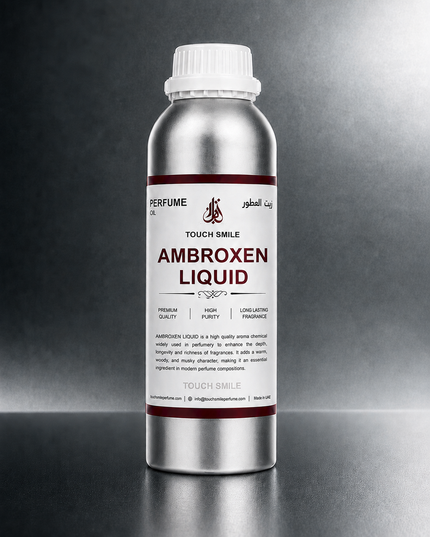 A silver metal bottle of Touch Smile Ambroxen Liquid perfume oil with a white cap, set against a dark gray gradient background.